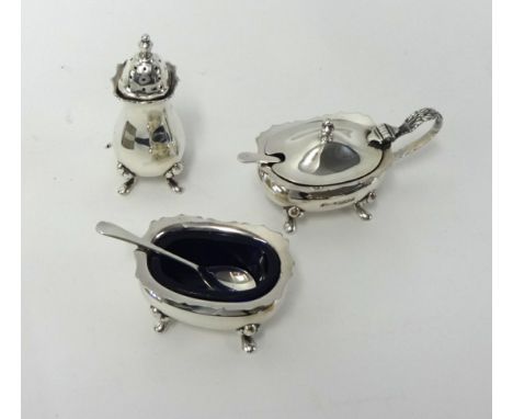 A modern silver three piece cruet set.
