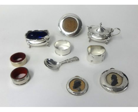 Various silver wares including table salt, napkin rings, mustard pot, miniature circular photo frames and white metal caddy s
