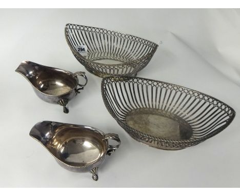 A pair of silver plated wire work oval table baskets, length 28cm, also a pair of 'Alpha' silver plated sauce boats (4).