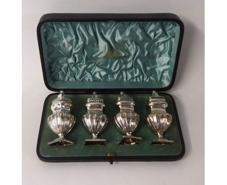 A set of four silver pepper pots, in original fitted case, James Usher, Lincoln, weight 6.15oz.
