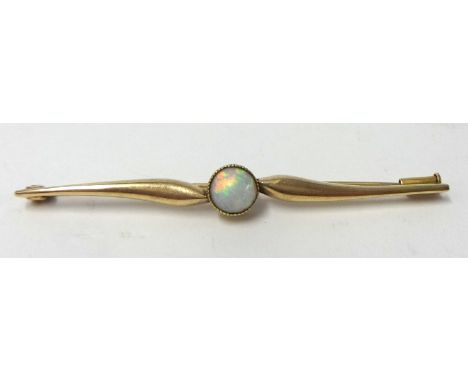 A gold and opal bar brooch, set with a single cabochon set opal, stamped .585.