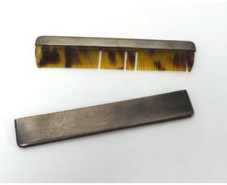 A silver cased comb.