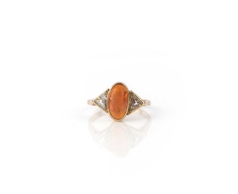 A fire opal and diamond ring, the oval fire opal flanked with triangular diamonds in 18ct yellow gold, London hallmarks for 1