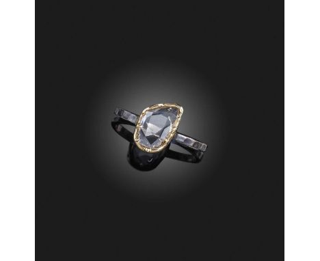 A diamond solitaire ring, the rose-cut diamond in a gold collet setting on a textured silver band, size L 1/2