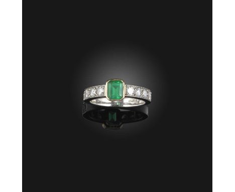 An emerald and diamond ring, collet-set with a step-cut emerald weighing approximately 0.90 carats, to shoulders set with bri