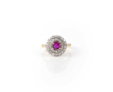 A ruby and diamond ring, of cluster design, set with a cushion-shaped ruby weighing approximately 0.40 carats, within a borde