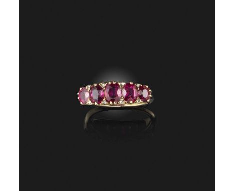 A Victorian ruby ring, late 19th century, set with a sequence of five cushion-shaped rubies, to a scrolled gold mount, size N