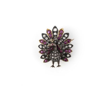 A Victorian ruby and diamond brooch, late 19th century, designed as a peacock, set with cushion-shaped rubies and rose-cut di