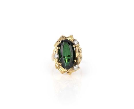 Φ Φ Alan Martin Gard, a tourmaline and diamond ring, circa 1970, claw-set with an oval step-cut green tourmaline, within a an