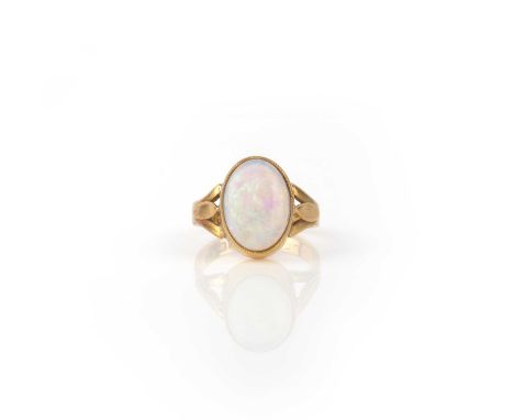 An opal ring, circa 1909, set with an opal cabochon, to a 22ct gold mount with stylised foliate shoulders, size P, British ha