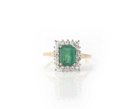 An emerald and diamond ring, of cluster design, set with a step-cut emerald, within a border of brilliant-cut diamonds, mount