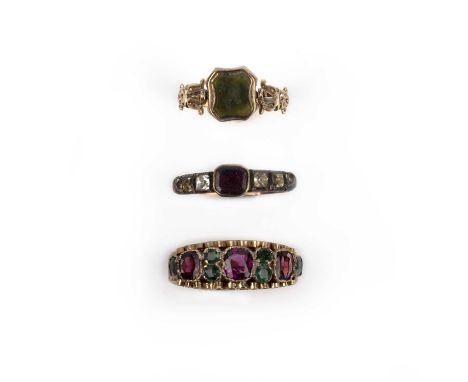 A collection of three gem-set rings, 18th and 19th centuries, comprising: a ring set with cushion-shaped garnets and emeralds