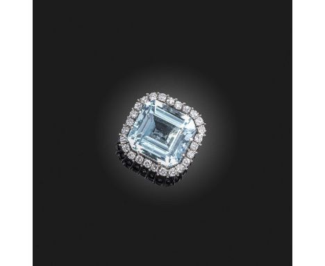 An aquamarine and diamond cluster pendant, the large step-cut aquamarine is set within a surround of diamonds in white gold, 