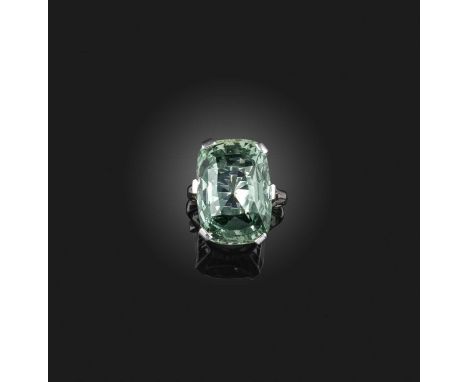 An unusual green beryl ring, claw-set with a cushion-shaped green beryl measuring approximately 21 x 15 x 10mm, to a silver m