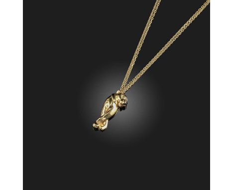 Cartier, a gold pendant, 'Panthère', depicting a collared panther, its eye set with a tsavorite garnet, its nose applied with