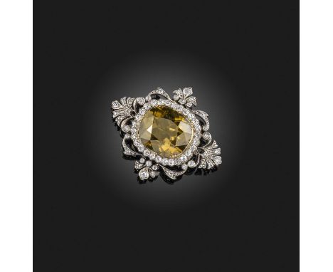 A Victorian zircon and diamond quatrefoil brooch, late 19th century, set with a brown cushion-shaped zircon within diamond bo