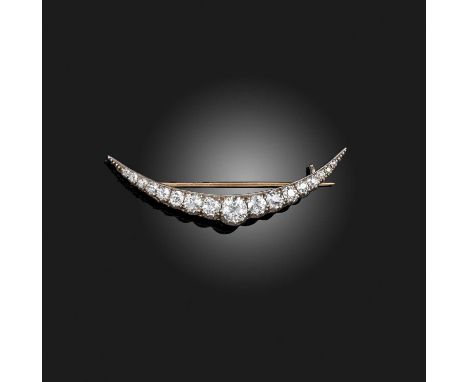 A Victorian diamond brooch, circa 1890, designed as a shallow crescent, set with circular-cut diamonds, mounted in silver and