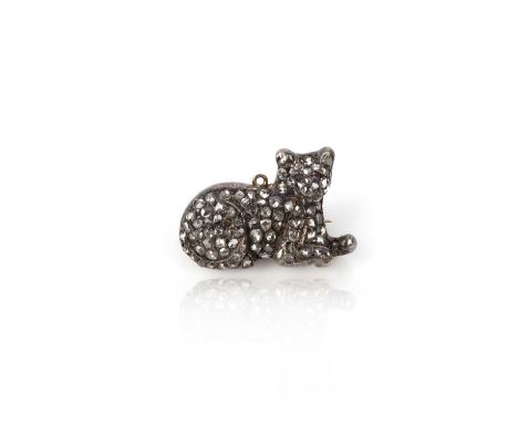 A diamond brooch, 19th century, designed as a recumbent cat, pavé-set with rose-cut diamonds, with ruby eyes, mounted in silv