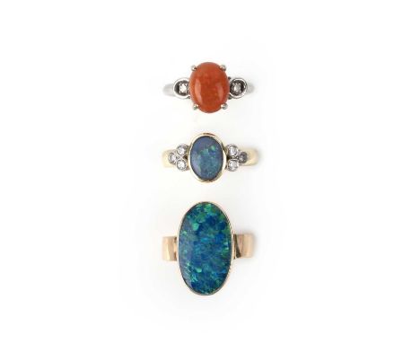 Three opal rings, comprising: a ring collet-set with a black opal, to shoulders set with trios of brilliant-cut diamonds, mou