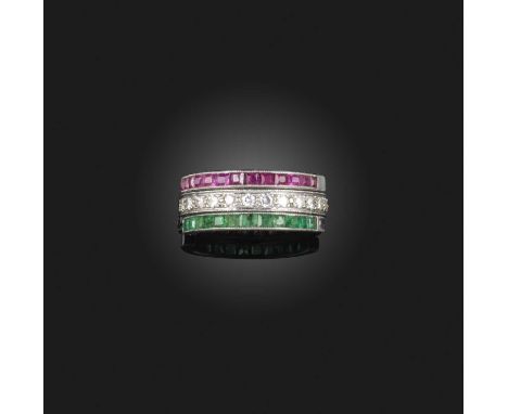 An Art Deco emerald, ruby and diamond adjustable 'day and night' eternity ring, early 20th century, designed as a full eterni