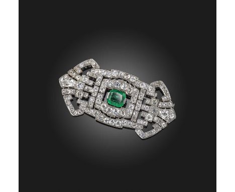 An Art Deco emerald and diamond brooch, of geometric design centring on a step cut emerald weighing approximately 4.60cts, wi