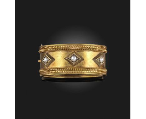 A Victorian gold, pearl and diamond bangle, late 19th century, the hinged gold cuff designed in the Archaeological Revival st