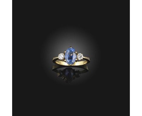 A sapphire and diamond ring, claw-set with an oval sapphire weighing approximately 3.00 carats, between shoulders set with br