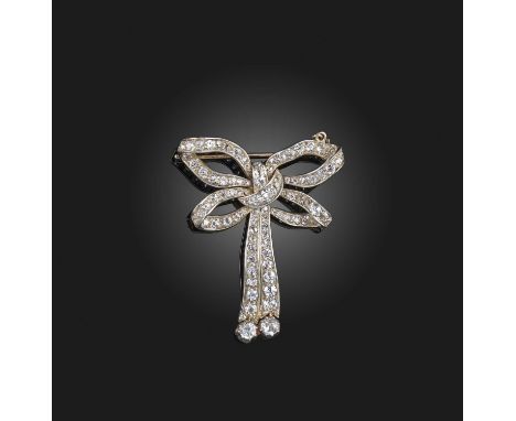 A diamond brooch, circa 1900, designed as a ribbon bow, set with circular-cut and cushion-shaped diamonds, mounted in silver 