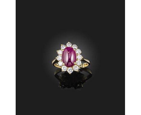 A ruby and diamond ring, of cluster design, centring on a cabochon ruby, within a surround of brilliant-cut diamonds, mounted