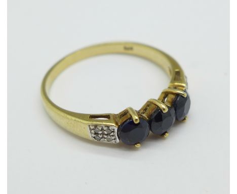 A 9ct gold and three stone sapphire ring with diamond shoulders, 2.1g, P