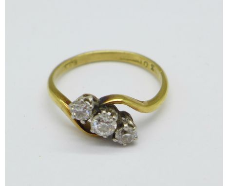 An 18ct gold and three stone diamond twist ring, 2.2g, K