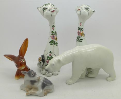 A Royal Copenhagen figure of a polar bear, a B &amp; G calf figure, a Goebel figure of a hare and two Italian cat figures