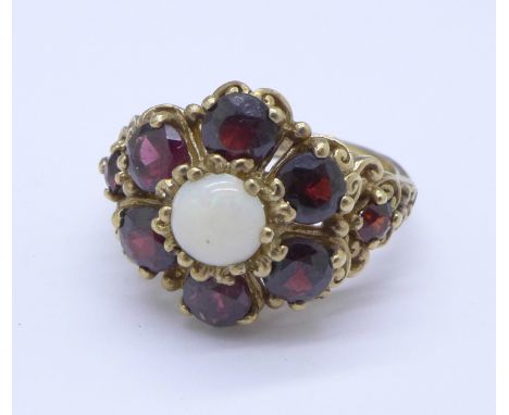 A 9ct gold, garnet and opal ring, 6.4g, P