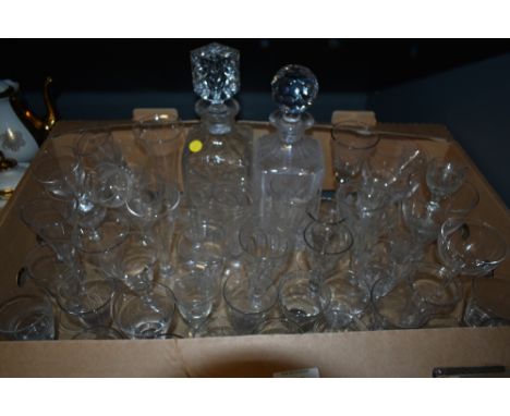 A carton of assorted vintage etched and plain spirit glasses and two cut glass decanters, one AF.