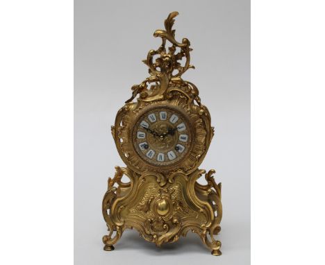 A Louis XV style gilt metal mantel clock the striking movement having an enamel mounted dial within a rococo case&nbsp;