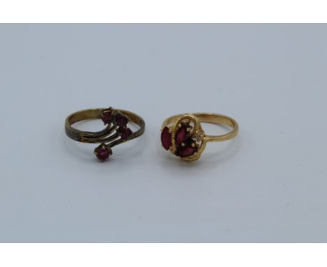 Two ruby set dress rings. One, set with three marquise rubies and a single round brilliant cut diamond, size M, stamped 585 a