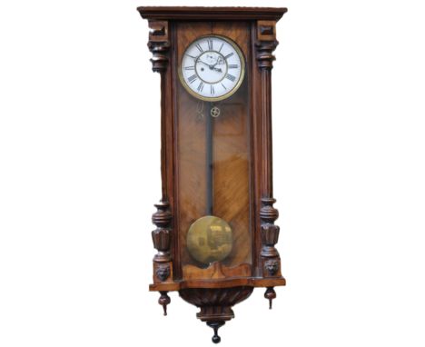 A walnut weight driven Vienna regulator with white enamel dial. 102cm high