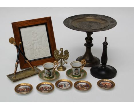 A quantity of Napolean Bonaparte related items including ceramic sauces, a pair of cups and saucers and bisque type relief pa