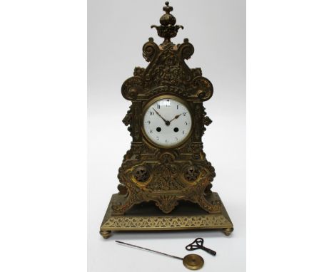 A 19th century mantel clock, the 10 cm diameter white enamel dial with Roman numerals, fitted a movement striking on a bell, 