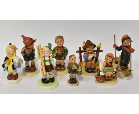 GOEBEL HUMMEL; eight figures of children to include skiers, boy and girl sitting on a bench holding flower, girl in Winter cl