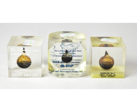 Three decorative paperweights, each containing a small sample of oil from various oil fields, comprising 'BHP The Lennox Oil 