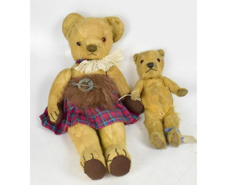 An early 20th century Merrythought small blond bear with glass eyes, pad paws and embroidered nose, length 29cm and an early 