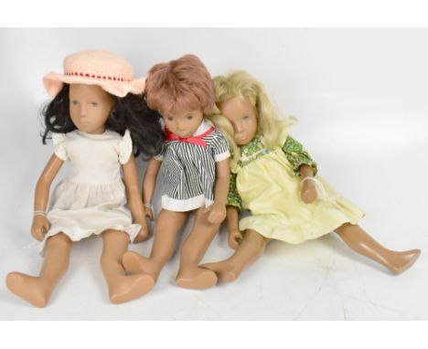 SASHA; three original dolls comprising a girl with long dark brown wavy hair, wearing a cream cotton dress with frilled sleev