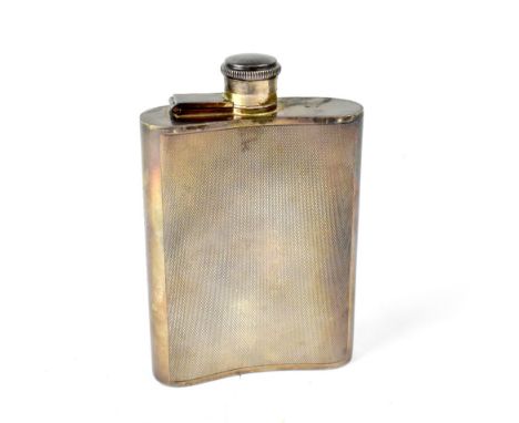 A George VI hallmarked silver hip flask with curved body and engine turned decoration, marked 'Size 1.5 Gill', Chester 1939, 