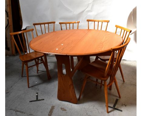 A contemporary pale oak drop-leaf circular dining table to slab supports, length when extended 73.5 x 107 x 119cm, and a set 