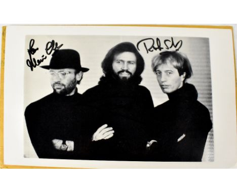 THE BEE GEES; a black and white printed stock photograph bearing the signatures of the band members.Footnote: Originally purc