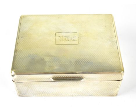 A George V hallmarked silver cigarette box with engine turned detail, central panel with initials 'RTF', wood lined interior,