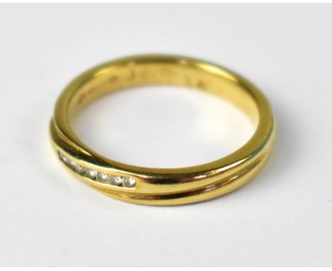 A 9ct gold ring set with seven pavé set tiny diamonds in crossover style, size N, approx 3.1g.