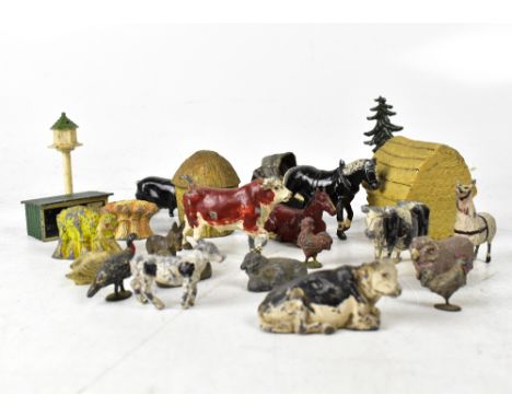 A quantity of early 20th century metal toys and miniature farm animals, to include beehive, cows, pigs, dovecot, hay bale, tr