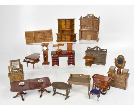 A quantity of boxed and loose miniature scale dolls' house furniture to include a kneehole desk, cabinets, chests of drawers,